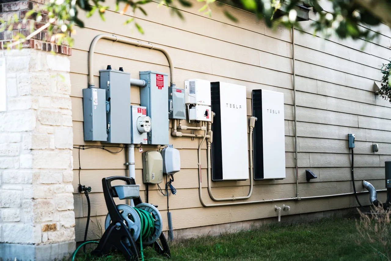 Whole-home battery backup system mounted beside the electrical service equipment