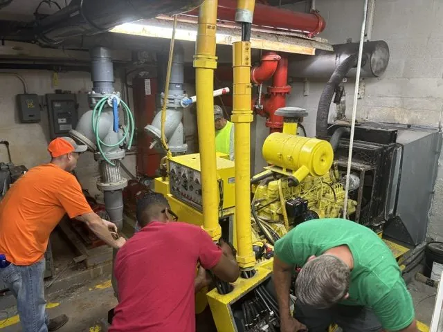 Wavelength Electrical Contracting crew installing a commercial standby generator in a mechanical room
