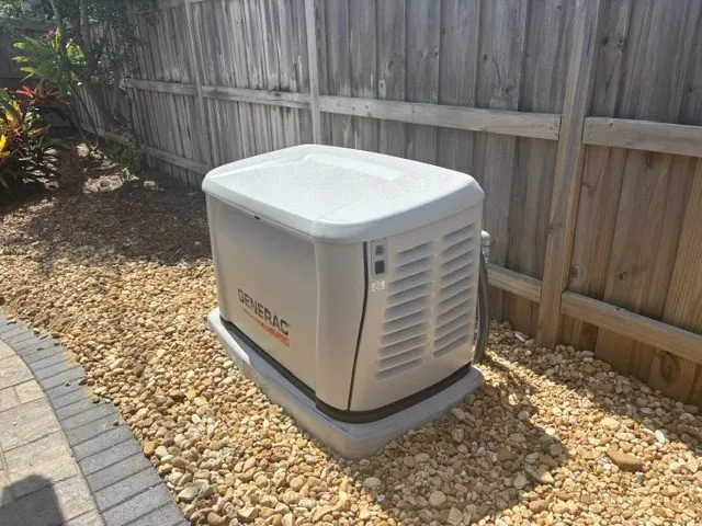 Generac Guardian standby generator installed on a concrete pad in a Brevard County backyard