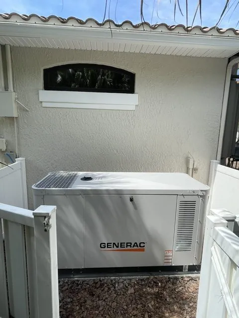 Generac home standby generator installed beside a stucco Florida home with a tile roof