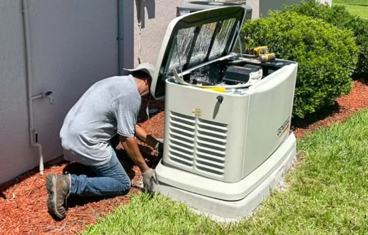 Electrician in Melbourne, FL installing a Generac backup generator