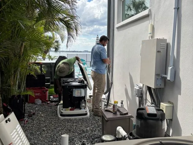 Wavelength technician installing a home standby generator beside a Melbourne, FL home