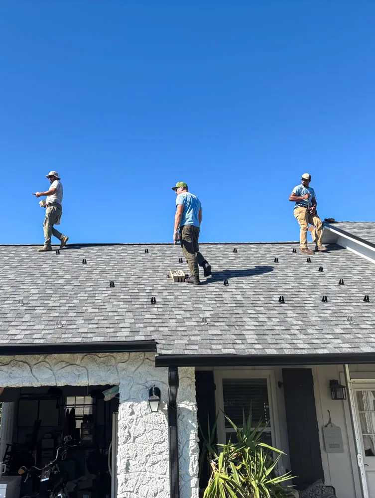 Solar installers working on a home roof in Melbourne, FL