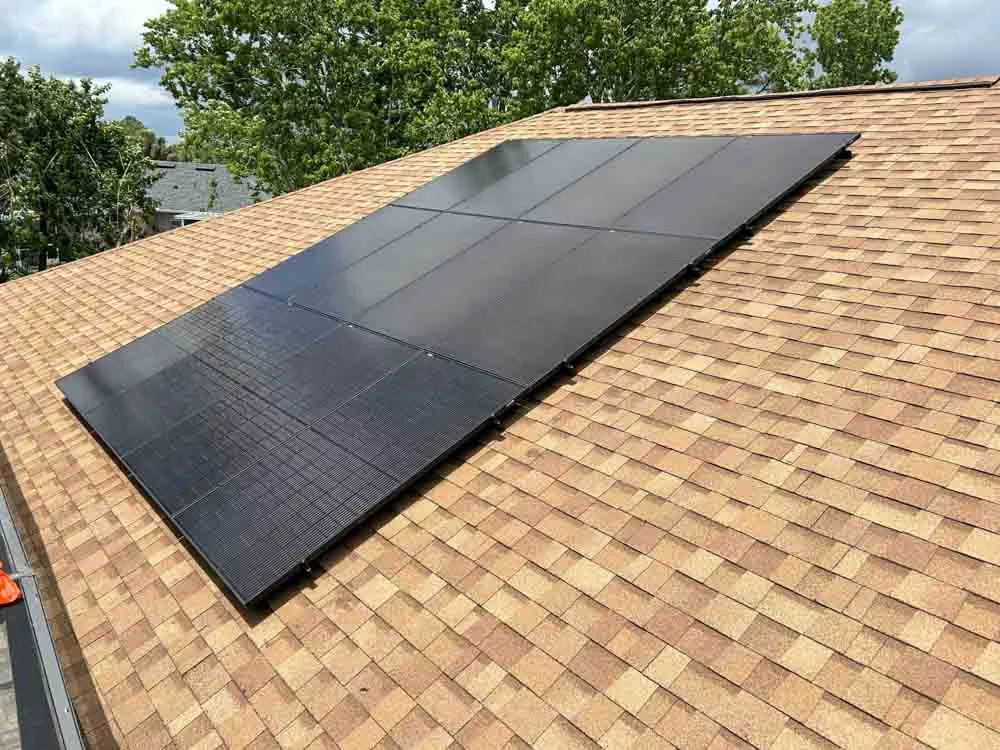 Black solar panel array installed on a shingle roof in Melbourne, FL