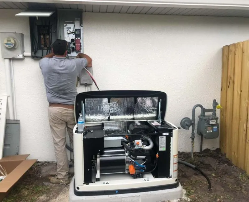 Electrical contractor installing a home generator outside a Melbourne, FL house