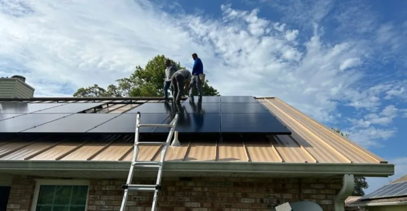 Technicians installing solar panels on a brick house roof in Melbourne, FL